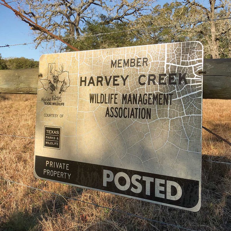 Harvey Creek sign on a wire fence