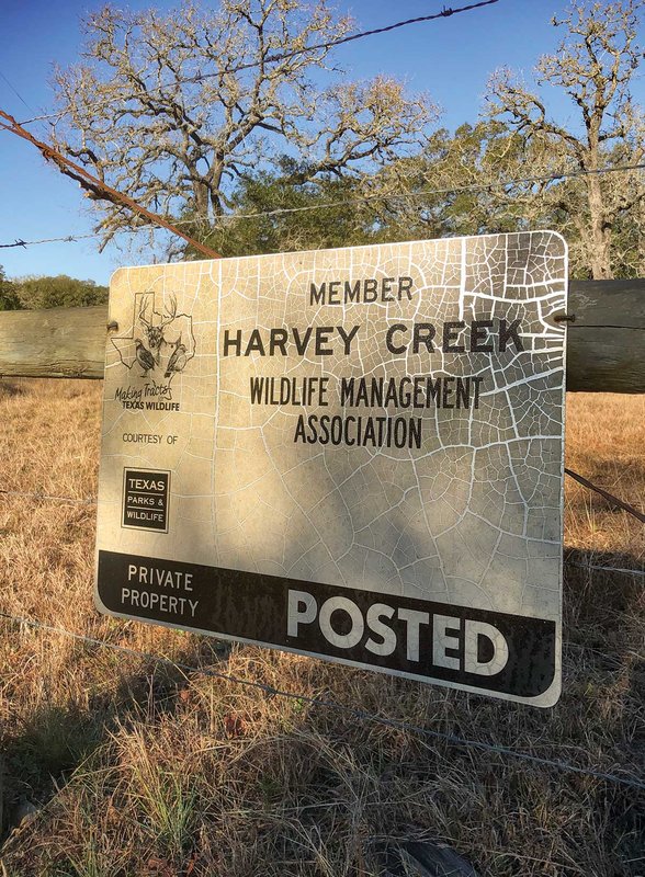 Harvey Creek sign on a wire fence