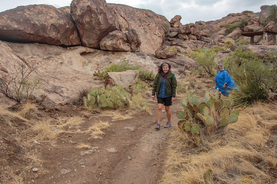 two people hiking at Hueco Tanks