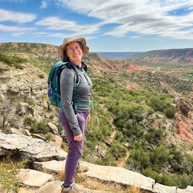hiker standing on the rim of Palo Duro Canyon