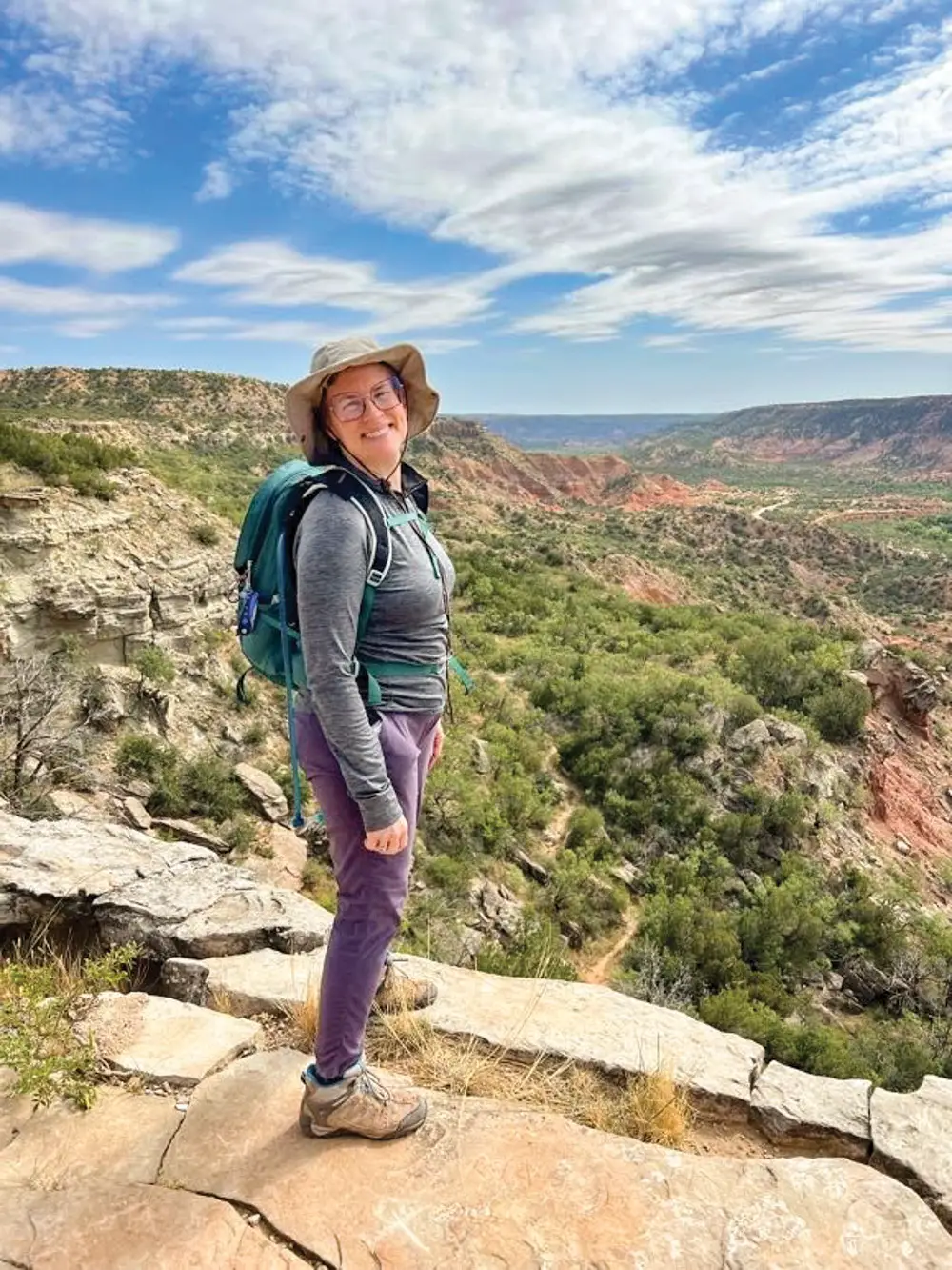 hiker standing on the rim of Palo Duro Canyon
