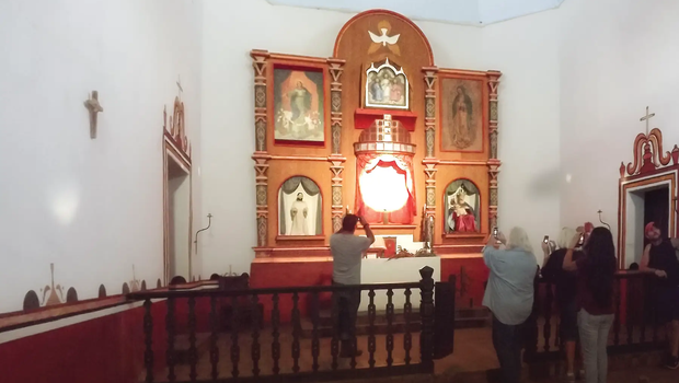 a crowd of people taking pictures during the illumination of Goliad State Park’s Mission Espíritu Santo alter