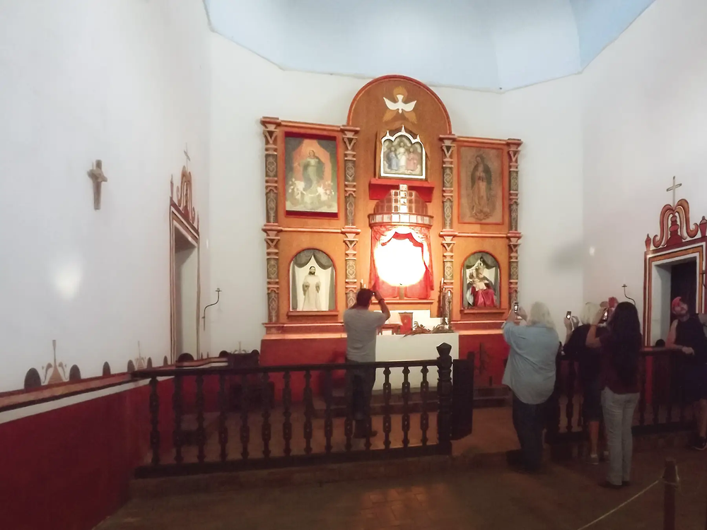 a crowd of people taking pictures during the illumination of Goliad State Park’s Mission Espíritu Santo alter