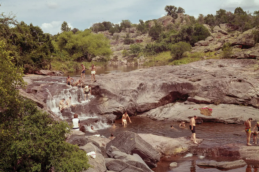 People at Inks Lake State Park splashing in the rocky pools