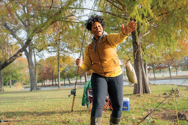 Jaz Robinson grabbing her dangling fishing line from the pole