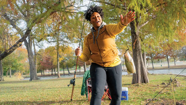 Jaz Robinson grabbing her dangling fishing line from the pole