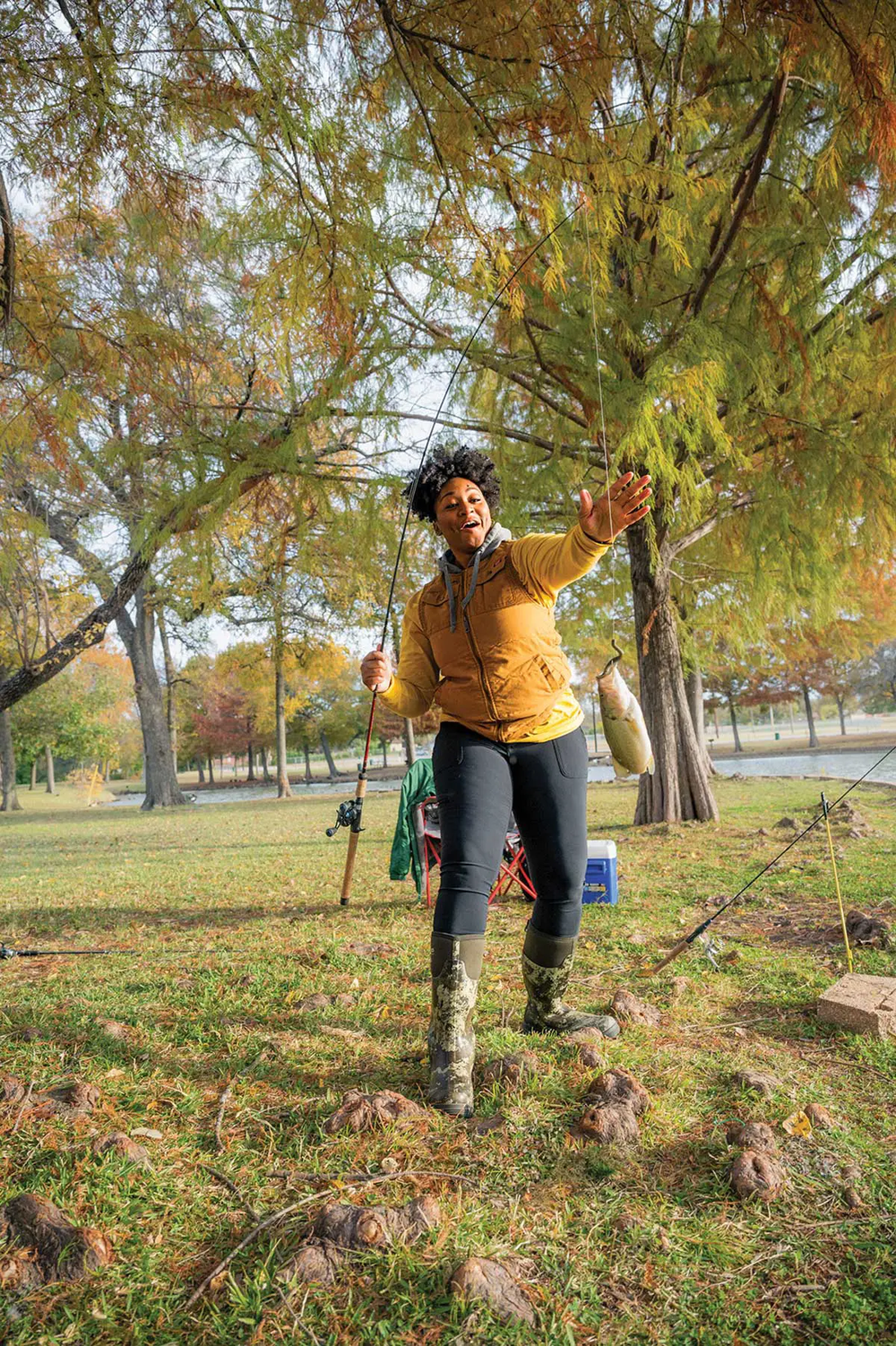 Jaz Robinson grabbing her dangling fishing line from the pole