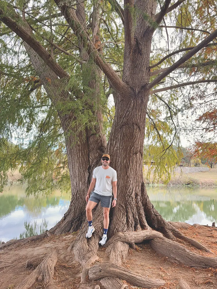John Sorsby leaning against a tree.