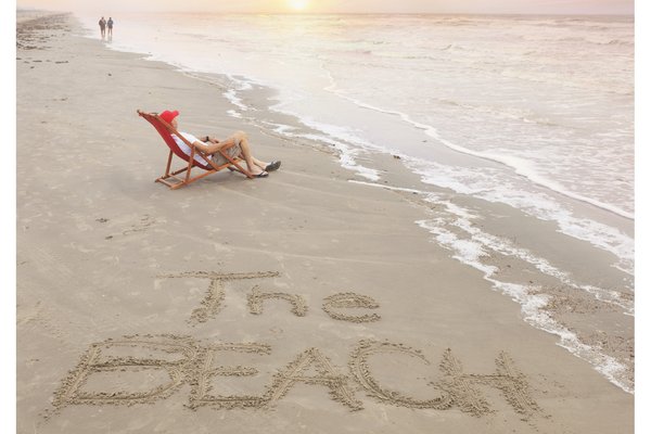 July 2024 cover of Texas Parks & Wildlife magazine, depicting a beach chair and the words 'The Beach Issue' written on the sand