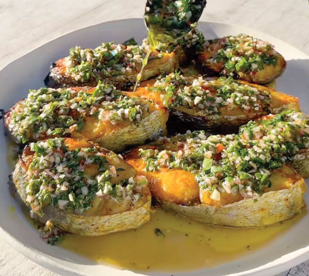 Roasted Spanish Mackerel  with Chimichurri Sauce on a plate.