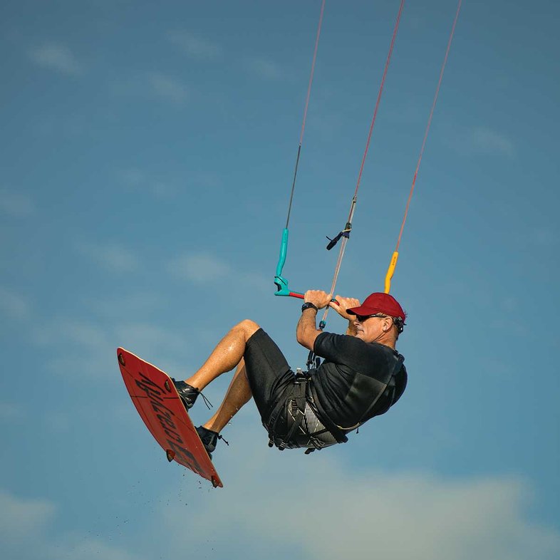 Man catching air on his kiteboard.