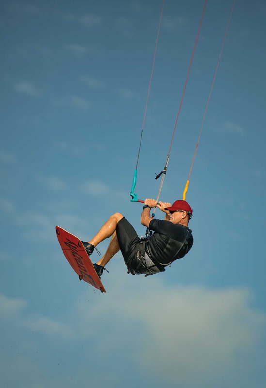 Man catching air on his kiteboard.