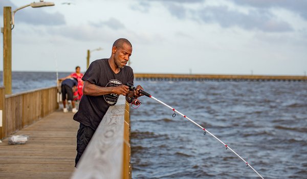 Man fishing from goose island fishing pier