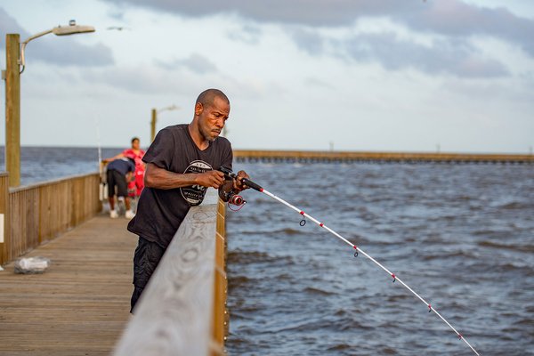 Man fishing from goose island fishing pier
