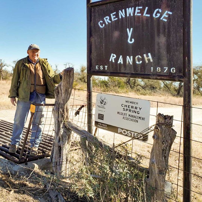 Man standing at the gate of Cherry Spring.