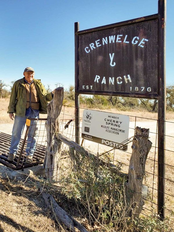 Man standing at the gate of Cherry Spring.