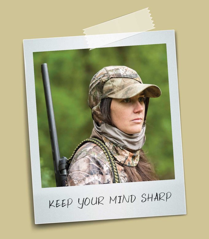 Person in camouflage with a gun on their back.