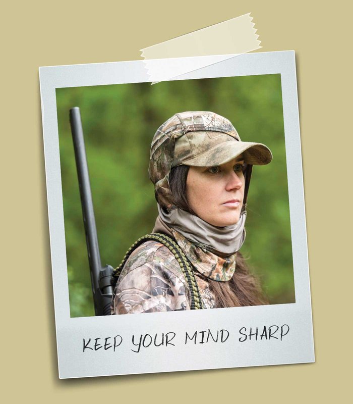 Person in camouflage with a gun on their back.