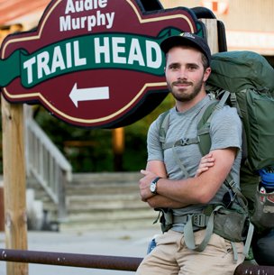 Hiker in front of Audie Murphy Trail Head