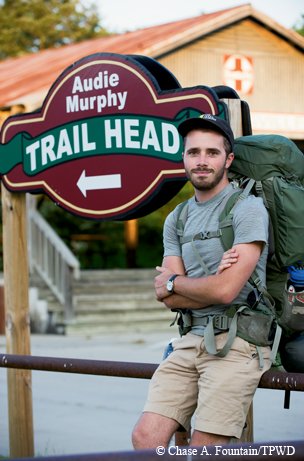 Hiker in front of Audie Murphy Trail Head