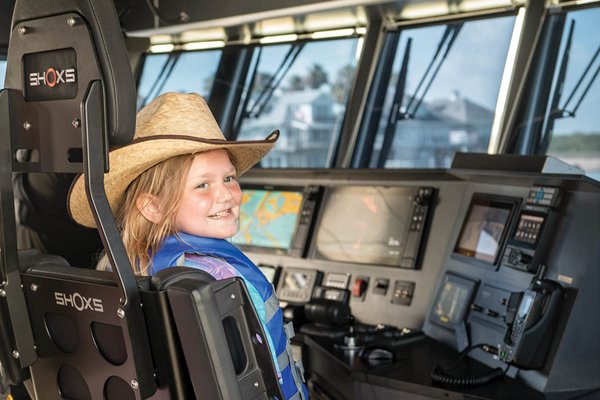 Natalee McCaleb steering a boat on her first Jr. Game Warden assignment.