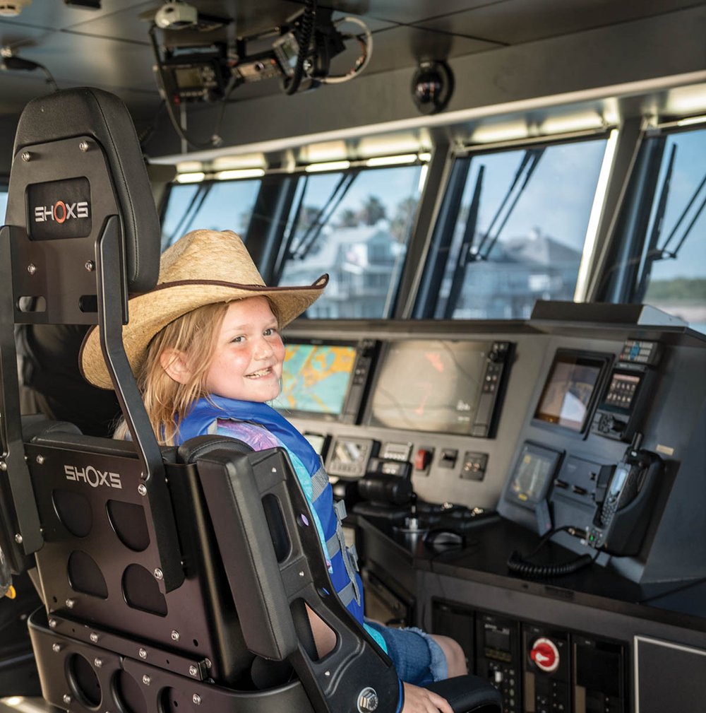 Natalee McCaleb steering a boat on her first Jr. Game Warden assignment.