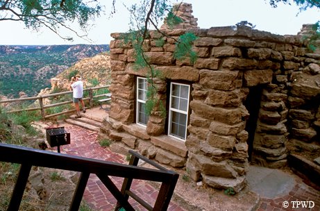Palo Duro cabins with man standing on balcony
