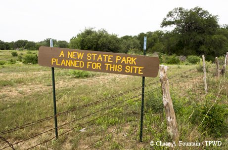 Palo Pinto field with a sign reading "A new state park planned for this site"