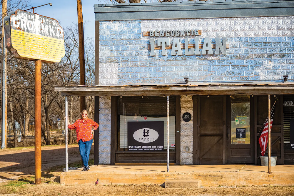 Palo Pinto Italian Restaurant with a person standing under the awning and an American flag