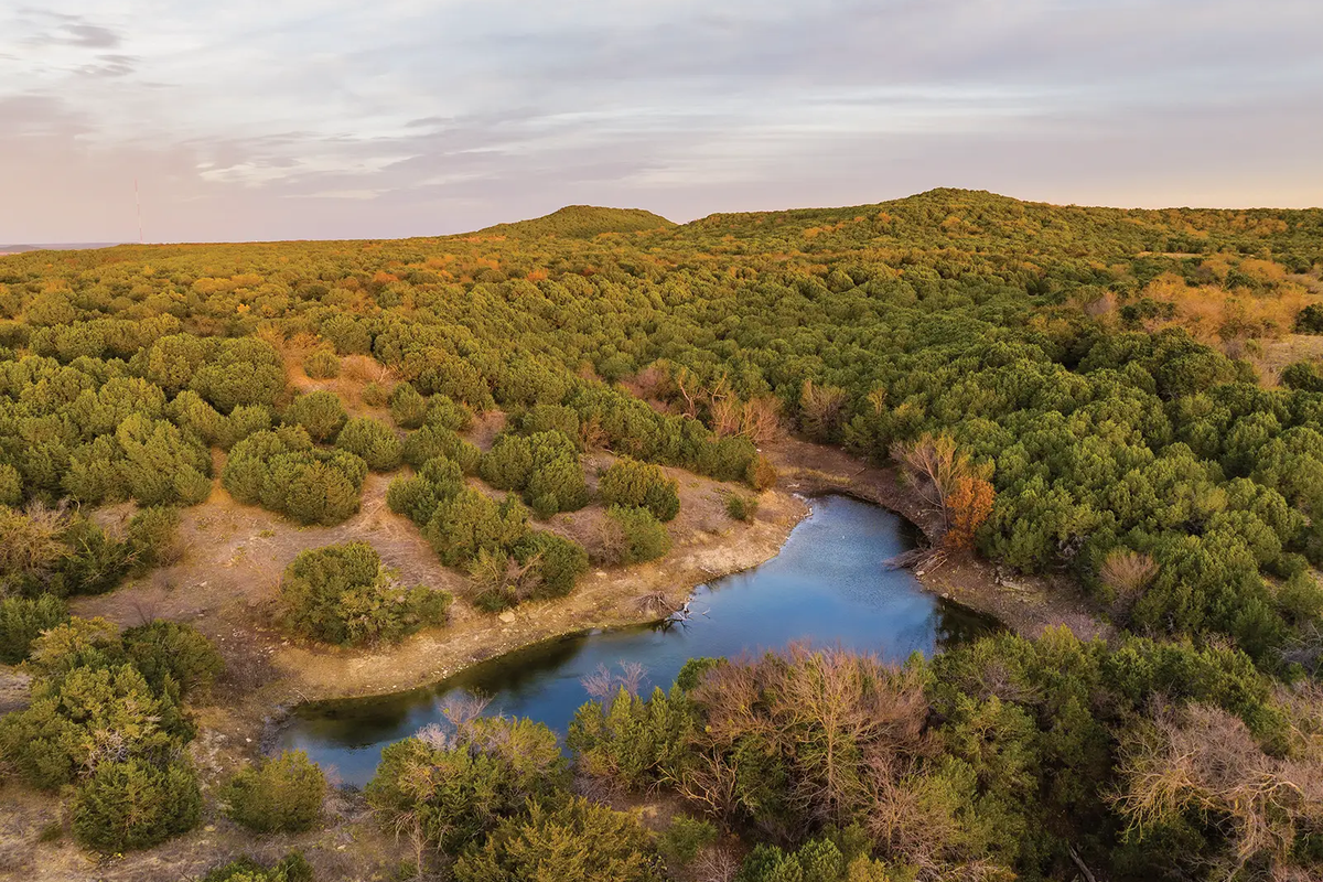 A river cutting through the brushy landscape of Palo Pinto State Park