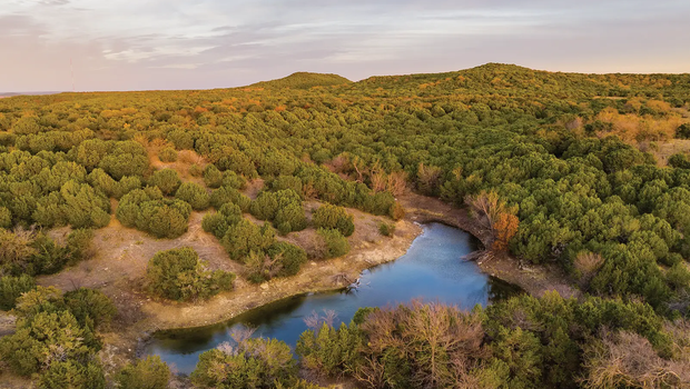 A river cutting through the brushy landscape of Palo Pinto State Park