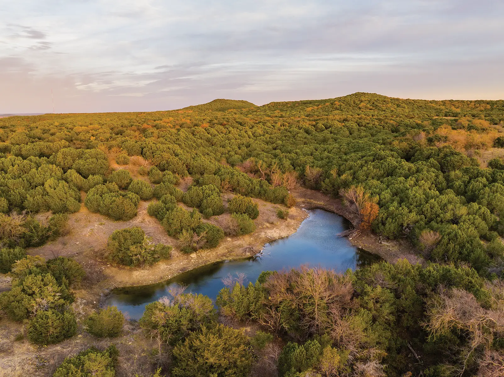 A river cutting through the brushy landscape of Palo Pinto State Park