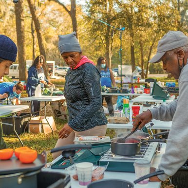 People cooking outdoors at Brazos Bend State Park.
