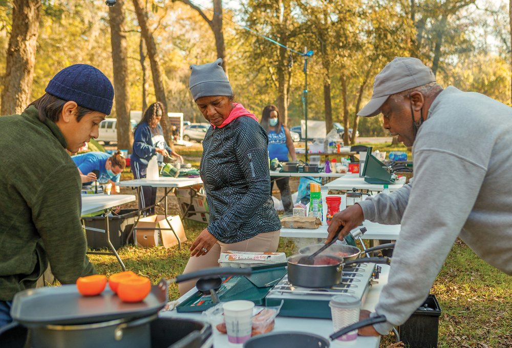 People cooking outdoors at Brazos Bend State Park.