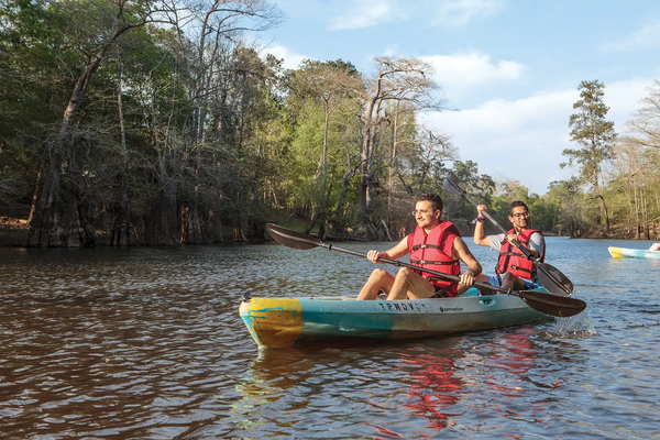 People in a canoe paddling at Village Creek State Park
