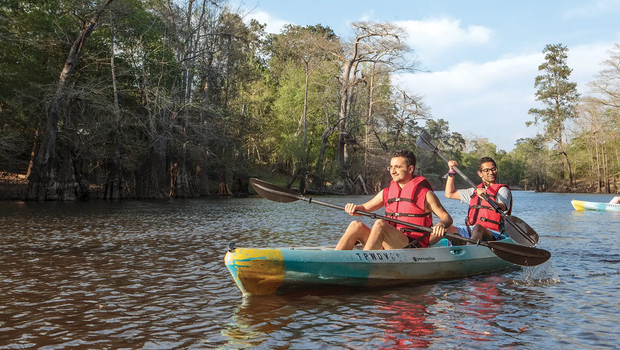 People in a canoe paddling at Village Creek State Park