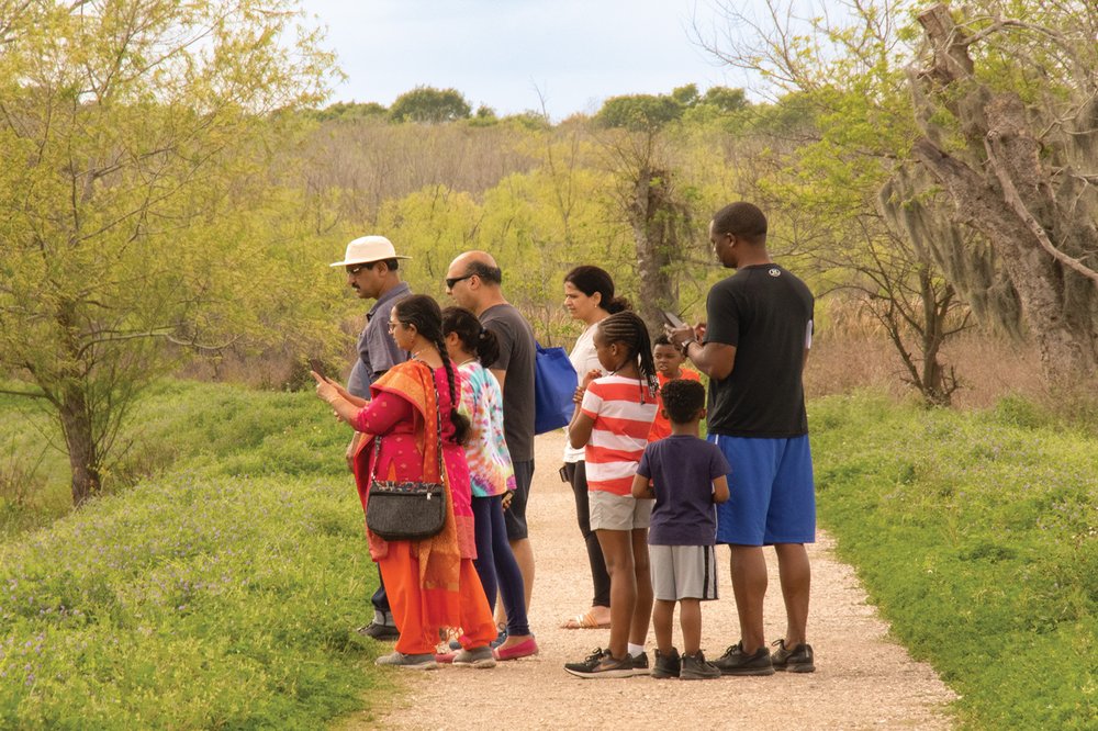 People on a trail looking at wildlife