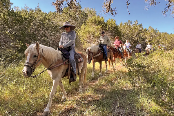People on horseback on a trail