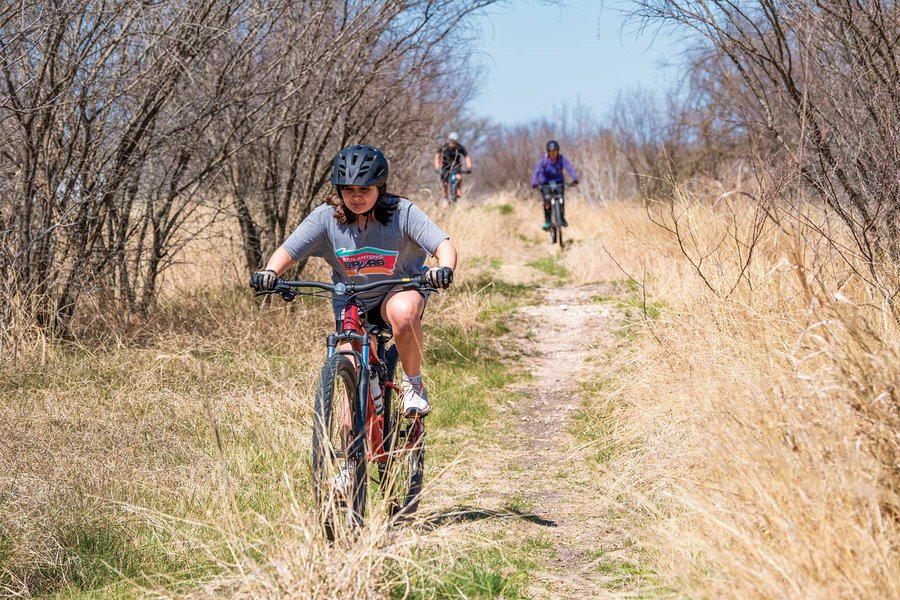People riding bikes on a trail.