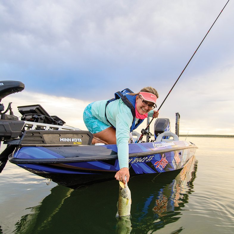 Person on boat pulling in bass on O.H. Ivie_3329