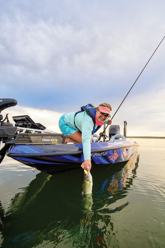 Person on boat pulling in bass on O.H. Ivie_3329