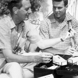 Walter Fondren lll showing a friend a fishing lure from his tackle box