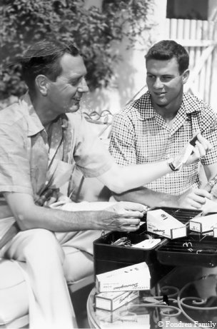 Walter Fondren lll showing a friend a fishing lure from his tackle box