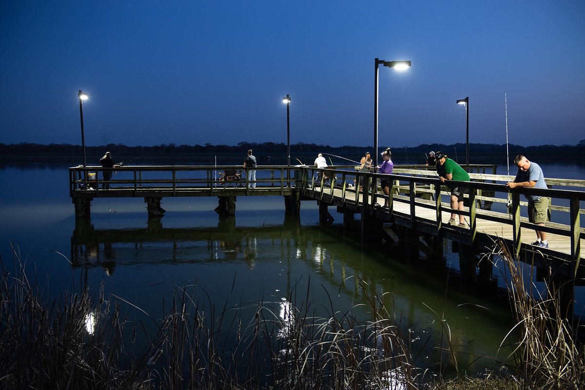 Purtis Creek pier lit up with people night fishing