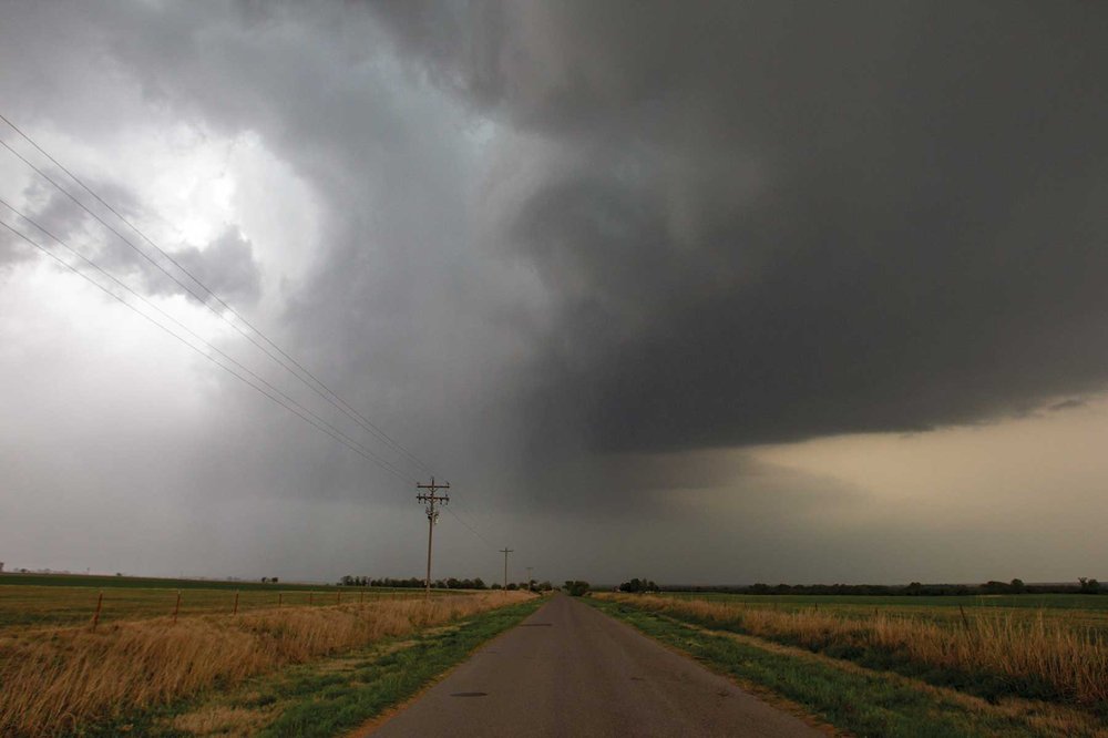 Rotating storm clouds over a field