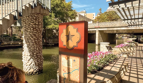 San Antonio River Walk with a woman looking at a map of the river walk