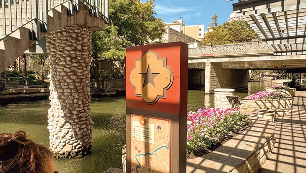 San Antonio River Walk with a woman looking at a map of the river walk