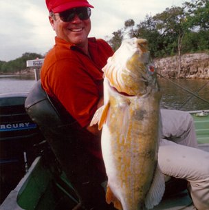 Walter Fondren lll in red showing a fish to the camera