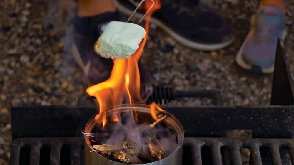 Roating marshmallow on a stick over a flame