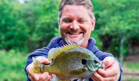 Shane Carter smiles with his bluegill catch